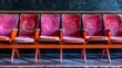 rows of pink seats in a cinema