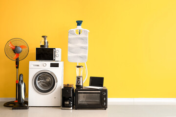 Wall Mural - Modern household appliances near yellow wall in room