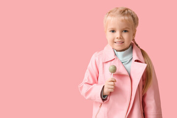 Wall Mural - Cute little girl with sweet lollipop on pink background