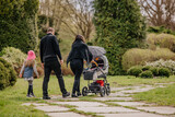 Fototapeta  - Rodzina z dzieckiem na spacerze w parku
