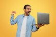 © Prostock-studio - Happy man celebrating with laptop