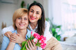 Close up photo of loving young adult female daughter congratulate her mature mother with mothers day. Birthday, Mothers day, women's day, retired, family, relation, motherhood.