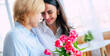 Banner image of happy daughter and mom with tulips bouquet. Birthday, Mothers day, women's day, retired, family, relation, motherhood.