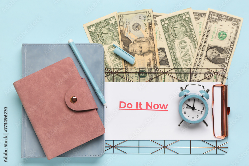Composition with text DO IT NOW, wallet and money on blue background. Time management concept. Top view