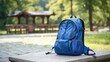A blue backpack is placed on top of a cement slab