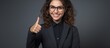 © AkuAku - A young woman with a cheerful smile wearing a formal business suit and glasses, confidently showing a thumbs up gesture