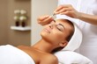 Woman getting  face treatment in spa beauty salon. Face care and massage with cosmetics in wellness center