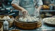 A close-up view of a chef's hands as they expertly prepare fresh dumplings in a bustling kitchen environment.