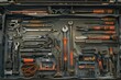 Focused view inside an engineer’s toolbox, revealing an assortment of tools used in field inspections.