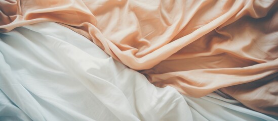 Poster - Cozy bed adorned with a soft white and orange blanket and a plush brown pillow for a comfortable night's sleep