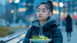 A young girl holding a bowl of salad