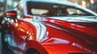 A close-up view of a striking red car parked on a bustling city street