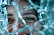 A woman with green eyes is smiling at the camera through a broken window