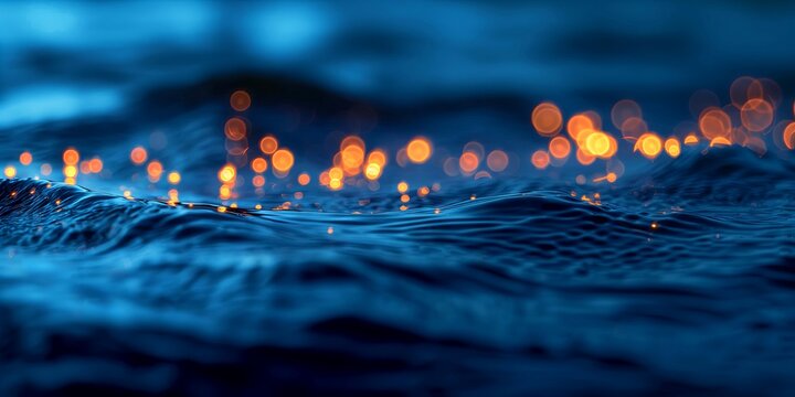 At night Dark blue water surface and orange lights with strong bokeh effect