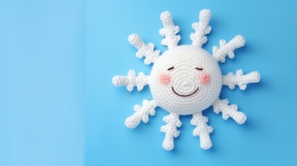 Wall Mural - Knitted, cute sun with a smile on a blue background, top view, with space for text. Greeting card, hobbies, knitting, children's toys.