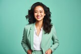 Fototapeta Zwierzęta - A successful East Asian businesswoman in her late 30s, against a gentle mint green background, flashing a radiant smile