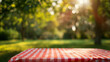 © nopommajun - A peaceful, soft-focus image highlighting a gingham tablecloth as gentle sunbeams filter through surrounding vegetation in a quiet park backdrop