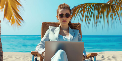 Teenager in suit working on computer on the beach under palms. Freelance online remote work concept. Pretty businesslike young girl using laptop in cafe on a tropical luxury beach resort. Working teen