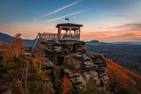 Fototapeta Na drzwi - Jetrichovice, Czech Republic - Aerial view of Mariina Vyhlidka (Mary's view) lookout with a beautiful Czech autumn landscape and colorful golden sunset sky in Bohemian Switzerland region
