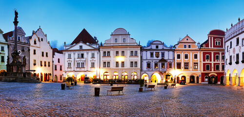 Wall Mural - Scenery of the Plaza in Cesky Krumlov, a medieval town in Czech Republic with colorful houses, monument in the square  before sunrise. Czech republic