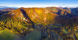 Fototapeta Zachód słońca - Drone mountain panorama with autumn forest.