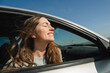 © Westend61 - Smiling woman with eyes closed feeling wind in car