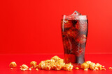 Fototapeta  - Cola with ice over red background