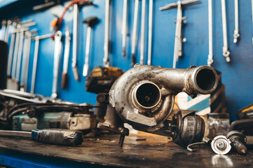 Wall Mural - Turbo motor on repairing desk in mechanic workshop