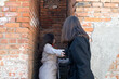 Two women at the dead end between the brick walls	