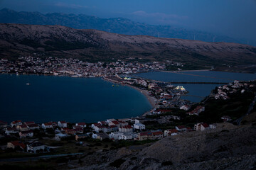 Wall Mural - Landscape with a city of Pag in Croatia during summer evening