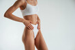 © standret - Woman in white underwear with slim body type against white background