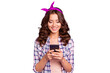 © deagreez - Cheerful charming careless carefree lady in checkered shirt casual wear with her brunette modern hairdo she hold cellular send message to friends isolated on bright violet background