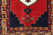Traditional Turkish carpet and kilim motifs. There are geometric motifs on a red background.	