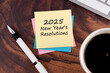 2025 New Year's resolutions text on adhesive note