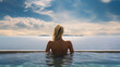 back view of woman relaxing in pool with sea view
