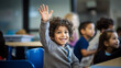 Smiling student raising his hand to ask a question during a classroom
