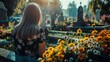 Woman visiting a grave at the cemetery and bringing flowers
