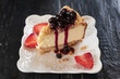 Japanese cheesecake with blueberry sauce and strawberry in the plate.