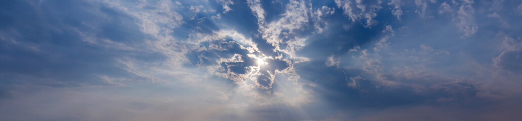 Wall Mural - The sun's rays. Sunbeam through the haze on blue sky. Rays of light shining down in the morning
