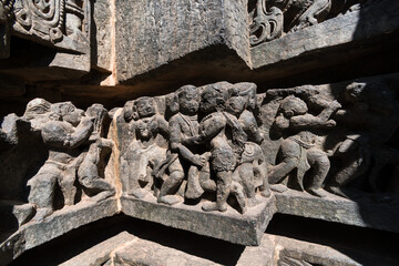 Poster - Beautiful carvings of romancing figurines on the wall of the ancient Hoysaleshwara temple in Halebeedu.