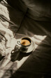 moody cup of coffee in bed. Morning coffe time.