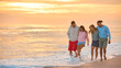 © Monkey Business - Hugging Couple With Friends In Casual Clothing On Vacation Walking Along Beach Shoreline At Dawn