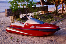 Red And White Jet Ski On The Beach. Old Jet Ski On A Sandy Beach By The Sea.