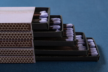 Wall Mural - lilac matchboxes stacks up on a blue background