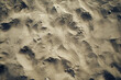 Detailed view of a sandy beach with multiple footprints imprinted in the sand
