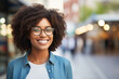 A woman with black hair and glasses is smiling on a city street, showcasing her vision care eyewear. She looks happy and cool, a true beauty while traveling