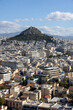 Picturesque view from Acropolis hill on Mount Lycabettus and the city skyline on a sunny day, Athens, Greece.