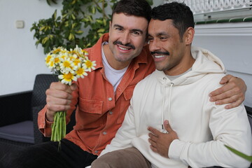 Wall Mural - Man gifting flowers to his handsome boyfriend 