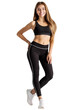 Young woman wearing a black sports bra top and leggings isolated on transparent background