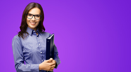 Canvas Print - Happy smiling businesswoman holding black folder. Portrait image - business woman at studio, isolated against violet purple wall background. Accounting manager. Account help. Real estate agent.